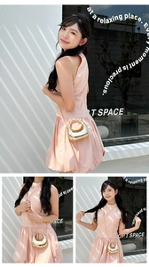 Detailed view of mini gold crescent bag with sleek handle and stylish chain strap