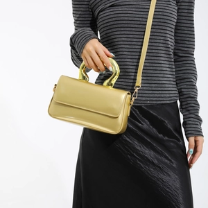 Golden acrylic mini square handbag with metallic U-shaped handle and detachable shoulder strap