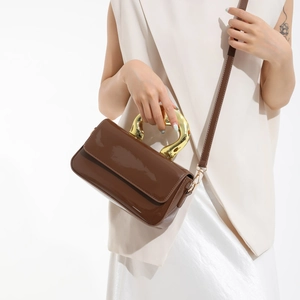 Coffee brown patent leather square bag with unique gold metal handle and crossbody strap
