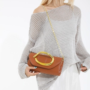 Classic brown leather clutch bag with gold oval metal handle and chain shoulder strap