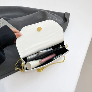 White leather crossbody chain bag with large interior capacity and magnetic clasp
