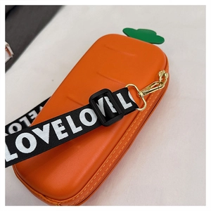 Macro view of carrot-shaped silicone pencil case with green leaves and LOVE strap