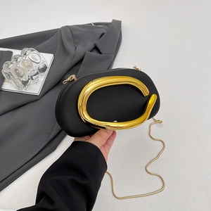 Chic black oval acrylic clutch with gold C-handle and crossbody chain strap