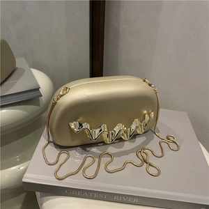Acrylic evening clutch bag with wavy gold wrist handle and thin snake chain strap