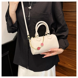 Chic cream-colored Boston bag with cute strawberry charms and gold chain detail