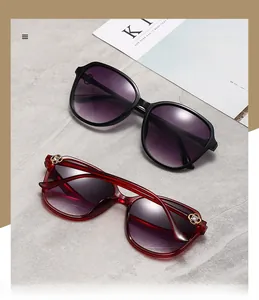 Detail view of large frame sunglasses with golden hollow floral temple and gradient lenses