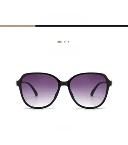 Detailed front view of oversized black sunglasses with purple gradient lenses and gold accents
