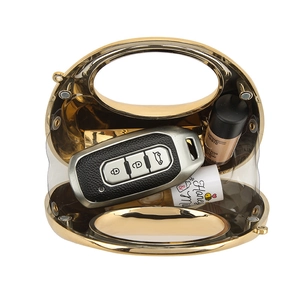 Golden crescent acrylic handbag with chain strap showing internal storage capacity