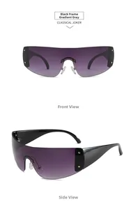 Close-up of oversized black frame sunglasses with gradient grey lenses and gold star studs