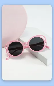 Detail of pink hollow frame sunglasses for kids with dark round anti-UV lenses