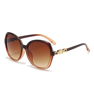 Elegant oversized gradient brown sunglasses for women with luxury gold chain detail on the temple