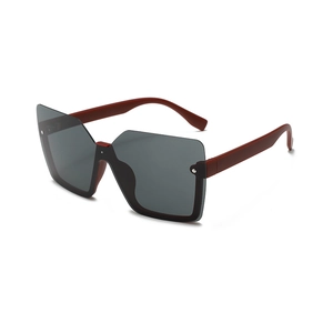 Futuristic frameless oversized sunglasses with dark grey lenses and reddish brown temples