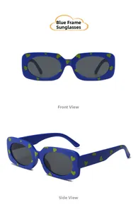 Detail view of royal blue heart-print kids sunglasses with brown lenses and green dots