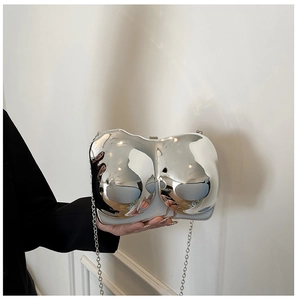 Artistic silver mirror-finish torso-shaped clutch bag with sleek metal chain strap