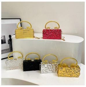 Detail of acrylic evening bags with unique ice-crack texture and golden dragon handles