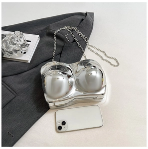 Detailed view of silver female torso shaped crossbody bag with a metal chain strap