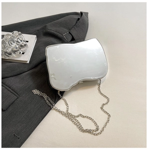 Detailed view of silver mirror geometric shoulder bag with sleek metal chain strap
