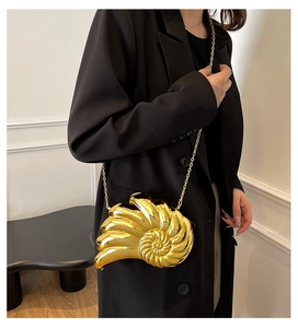 Creative gold conch-shaped evening bag with a metallic chain strap and spiral texture