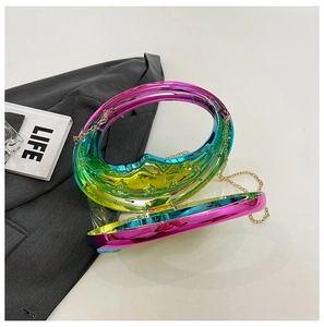 Detail of holographic acrylic moon bag with golden chain and metallic hinge closure