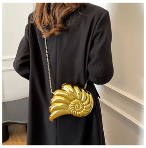 Detailed view of the gold shell-shaped nautilus bag with metallic acrylic chain texture