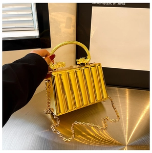 Detailed close-up of golden acrylic evening bag with ice-crack texture and dragon handles