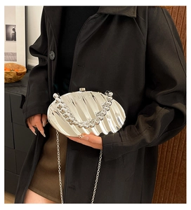 Chic silver shell-shaped acrylic clutch with metallic stripes and elegant bead handle