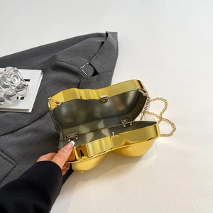 Golden heart-shaped mirror clutch bag with chain strap shown at a 45-degree angle