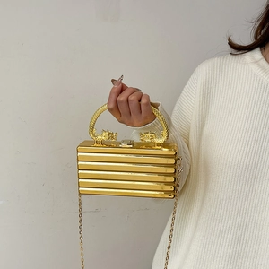 Golden acrylic evening clutch with luxury dragon handle and metallic chain strap