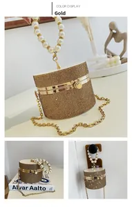 Macro view of gold round cylinder evening bag with rhinestones and pearl handle