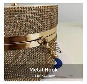Close-up of golden metal clasp and sparkling rhinestone surface on cylindrical evening bag