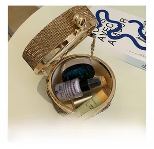 Detailed interior of champagne rhinestone evening bag showing cosmetic storage capacity