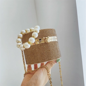 Elegant gold rhinestone cylinder evening bag with large pearl handle and metal chain
