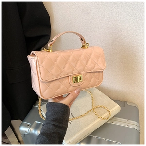 Detailed view of pink patent leather crossbody bag with quilted pattern and gold twist lock