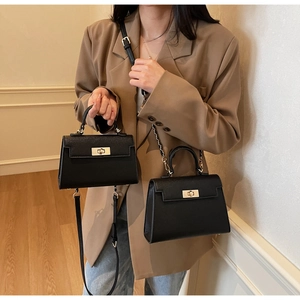 Detail of classic black pebbled leather tote bags showing size comparison and hardware