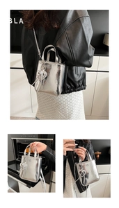 Close-up of metallic silver crossbody bag with wrinkled texture and heart charm detail