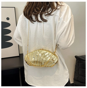 Golden hard shell clutch bag with shell-like pleats and elegant gold bead chain