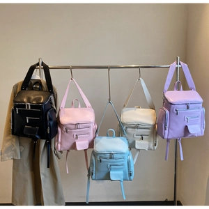 Row of colorful multi-pocket leather backpacks in black, pink, blue, beige, and purple