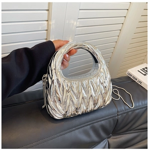 Detailed view of silver metallic crescent bag with matelassé pleated texture and chain