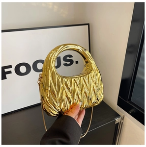 Detail of gold crescent evening bag with vertical pleated texture and metal chain