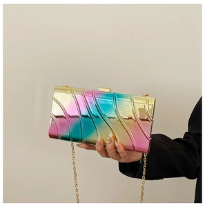 Detail of colorful metallic evening clutch with wave texture and gold chain strap
