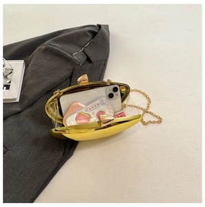 Internal view of the gold oval evening clutch showing capacity and metal chain strap