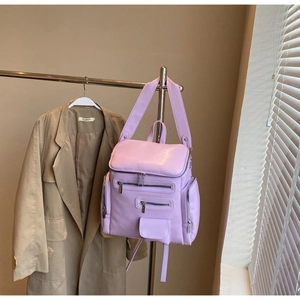 Lavender purple leather convertible backpack with multiple front zip pockets on hanger