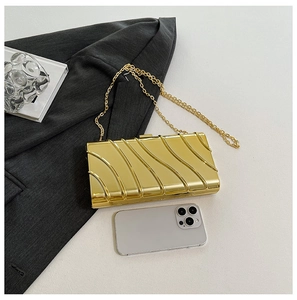 Gold textured evening clutch with detachable chain strap shown next to a smartphone