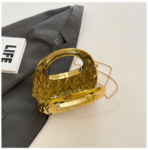 Detail of a crescent acrylic evening bag with gold fluid wavy texture and metal chain strap