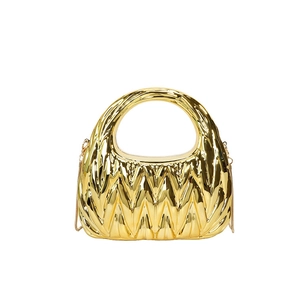 Detail of gold hobo evening bag featuring metallic quilted texture and chain strap