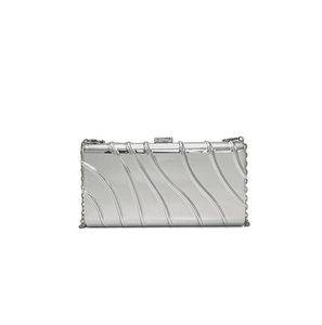 Detail of silver evening clutch featuring wavy 3D texture and metallic clasp closure