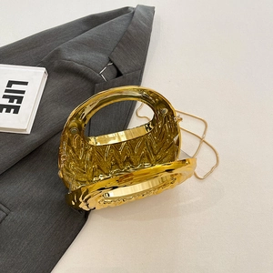 Golden acrylic crescent handbag with wave texture and chain strap on light background