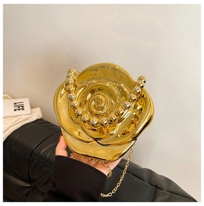 Detailed view of the golden rose carved acrylic box bag with beaded handle and chain