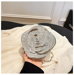 Detailed view of silver metallic rose-shaped evening bag with detachable chain strap