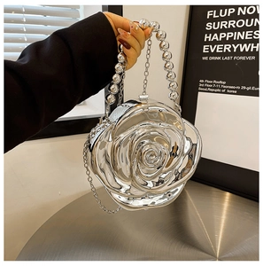 Detailed view of silver mirror rose clutch bag with large round bead handle and chain